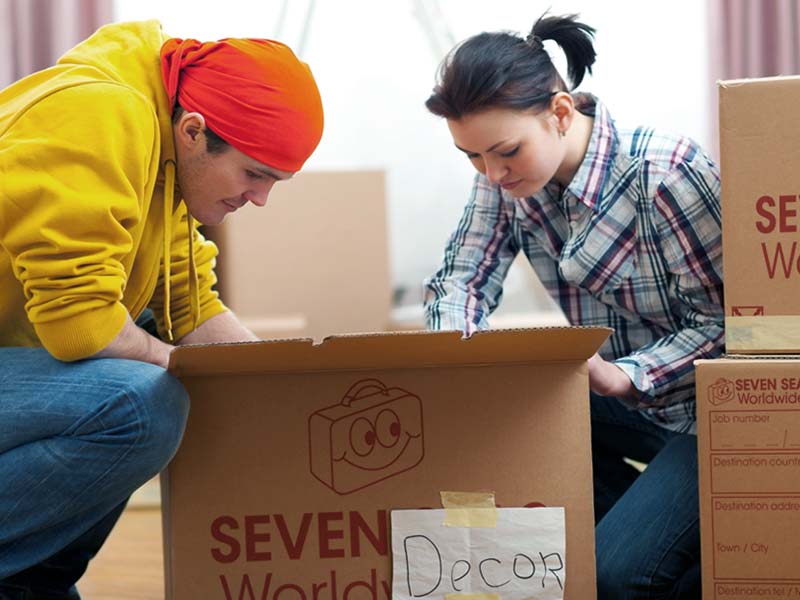 Couple packing cardboard boxes
