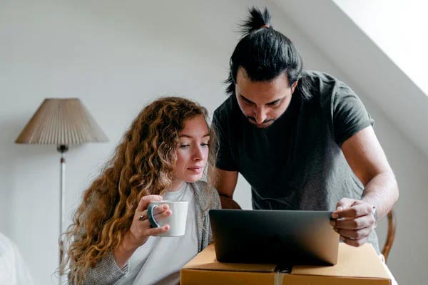 couple booking on laptop